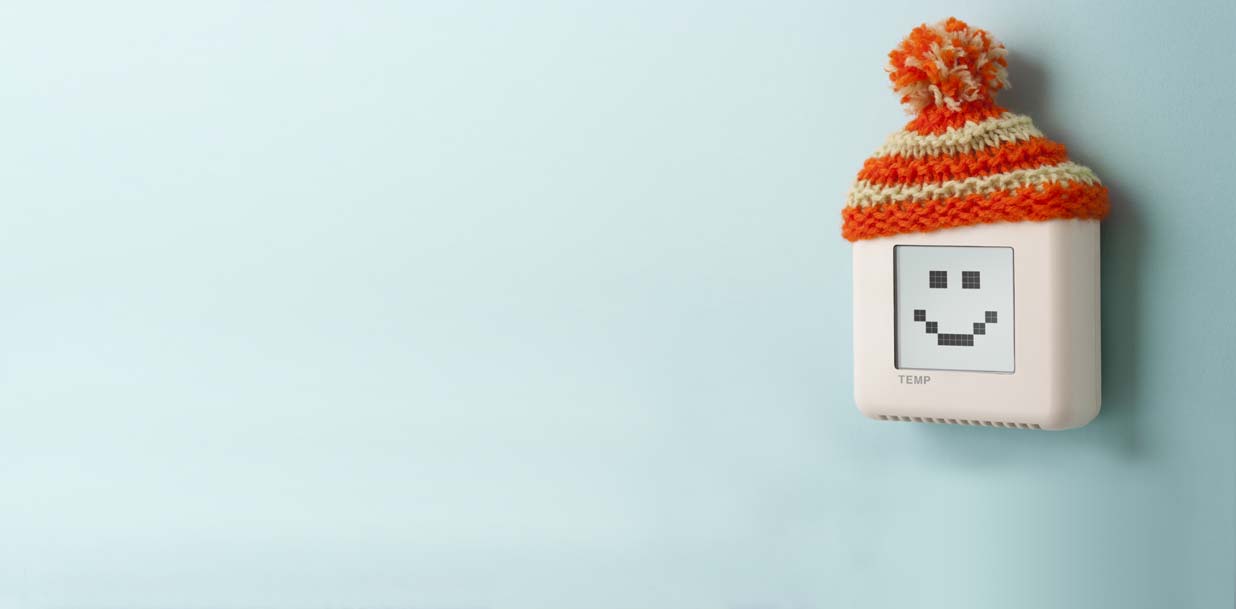Digital room temperature thermostat with smiley face and wooly hat